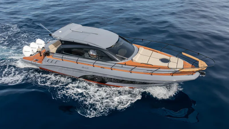 Slide: The Image of Sleek 2025 Hanover 415 yacht cruising on open water. - 2
