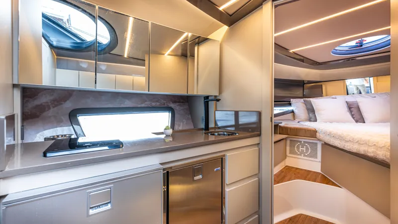 Slide: The Image of Luxurious interior of 2025 Hanover 415 yacht with modern kitchen and cozy bedroom. - 9