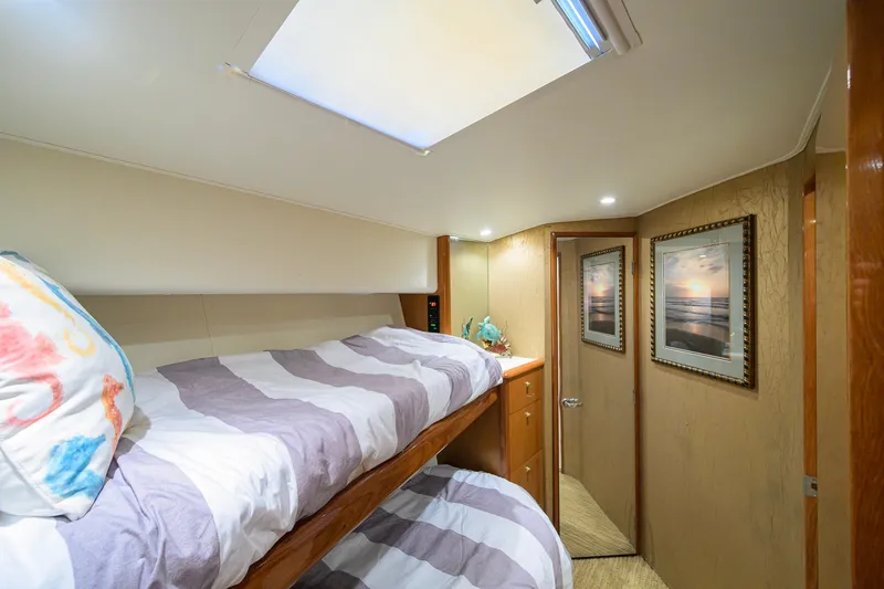Slide: The Image of Interior of 2001 Viking 55 Convertible yacht with cozy bunk beds and framed artwork. - 71