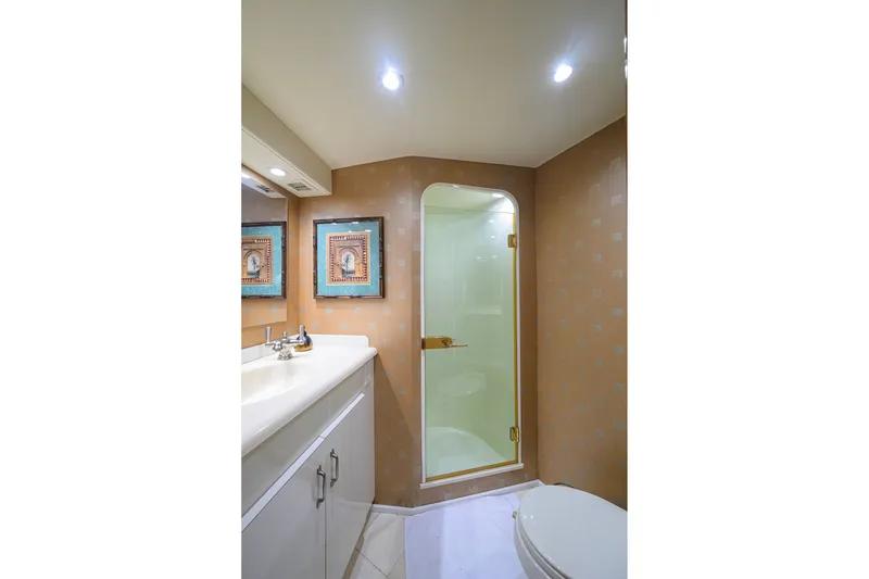 Slide: The Image of Luxurious bathroom in 2001 Viking 55 Convertible yacht with shower, vanity, and elegant decor. - 62