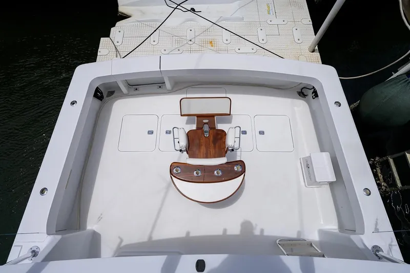 Slide: The Image of 2001 Viking 55 Convertible boat deck with fishing chair and storage compartments. - 16