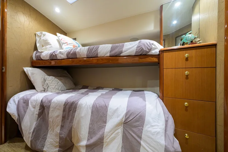 Slide: The Image of Bunk beds in a 2001 Viking 55 Convertible yacht cabin with striped bedding. - 68