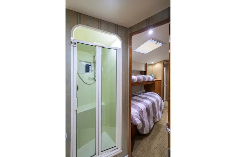Slide: The Image of Interior of 2001 Viking 55 Convertible yacht with shower and bunk beds. - 54