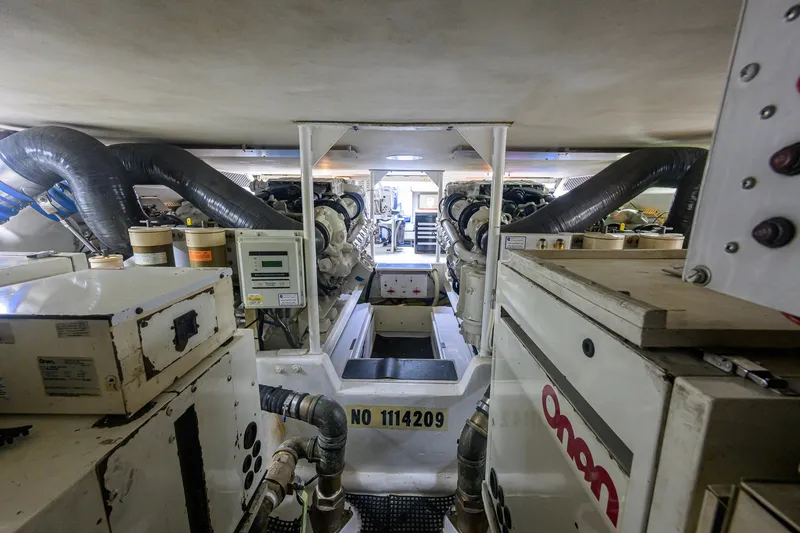 Slide: The Image of Engine room of a 2001 Viking 55 Convertible yacht, showcasing machinery and equipment. - 77