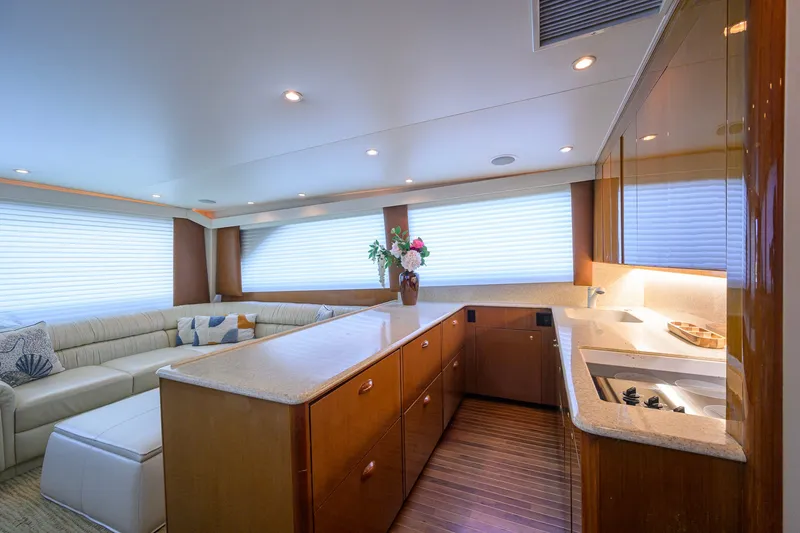 Slide: The Image of Luxurious interior of a 2001 Viking 55 Convertible yacht with modern kitchen and seating area. - 47