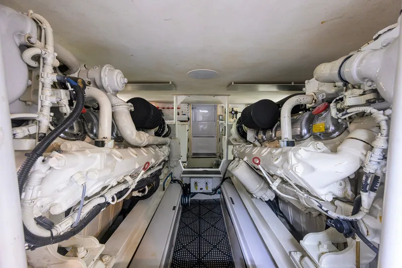 Slide: The Image of Engine room of a 2001 Viking 55 Convertible yacht, showcasing dual engines and mechanical components. - 76