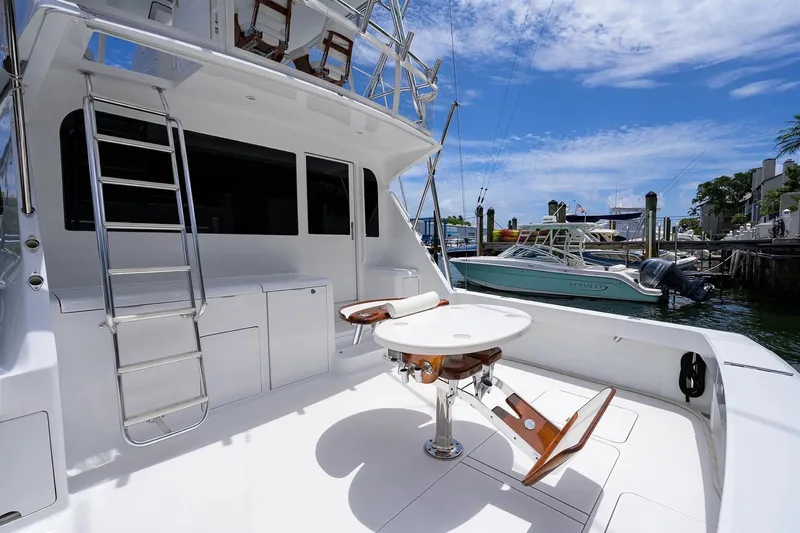 Slide: The Image of 2001 Viking 55 Convertible yacht deck with ladder and seating, docked at marina. - 24
