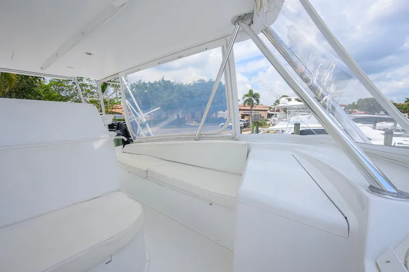 Slide: The Image of Interior view of a 2001 Viking 55 Convertible yacht with white seating and clear windows. - 35