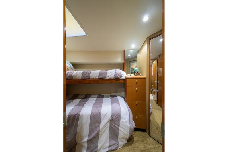 Slide: The Image of Interior of 2001 Viking 55 Convertible yacht with bunk beds and wooden cabinetry. - 72