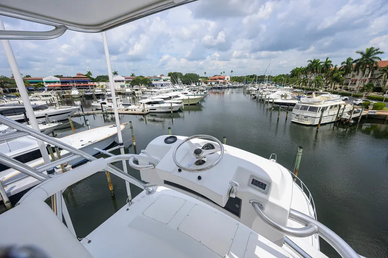 Slide: The Image of View from a 2001 Viking 55 Convertible yacht overlooking a marina with numerous boats. - 36