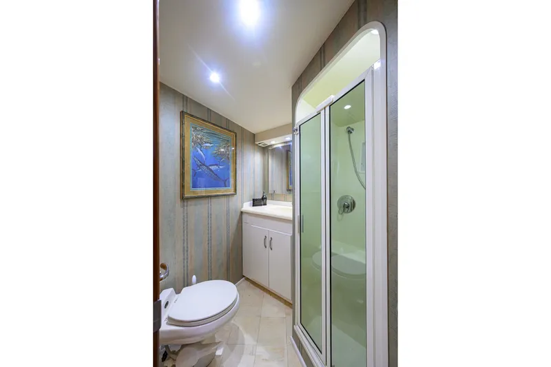 Slide: The Image of Bathroom interior of 2001 Viking 55 Convertible yacht with shower and artwork. - 74