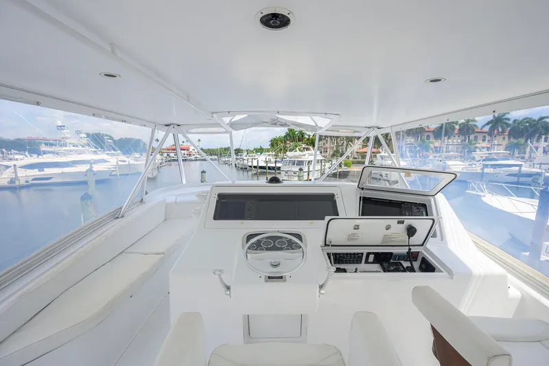 Slide: The Image of 2001 Viking 55 Convertible yacht helm with marina view, featuring modern navigation equipment. - 29