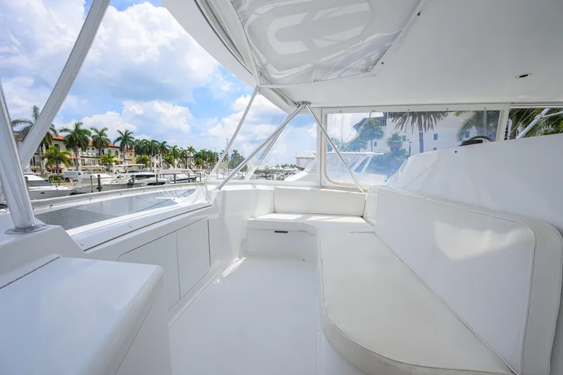 Slide: The Image of Spacious interior of 2001 Viking 55 Convertible yacht with white seating and marina view. - 34