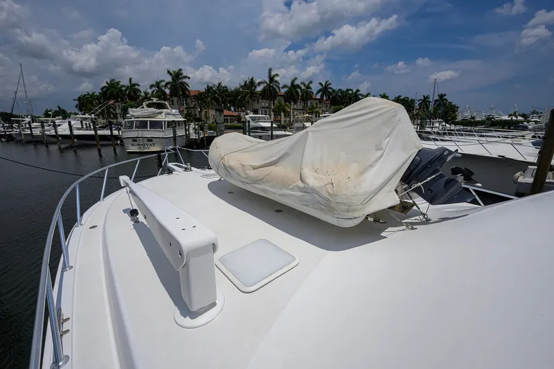 Slide: The Image of 2001 Viking 55 Convertible yacht docked, covered equipment on deck, marina background. - 14