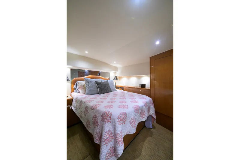 Slide: The Image of Luxurious bedroom interior of 2001 Viking 55 Convertible yacht with elegant bedding. - 55