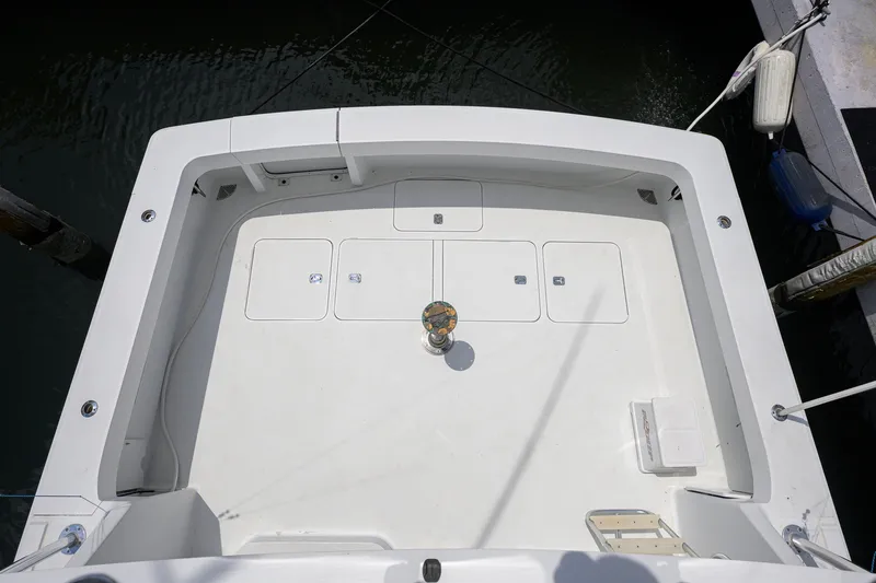 Slide: The Image of 2001 Viking 55 Convertible boat deck, spacious and clean, docked at marina. - 18