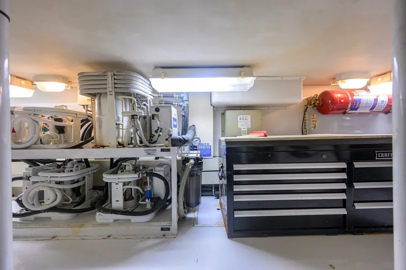 Slide: The Image of Engine room of 2001 Viking 55 Convertible yacht with equipment and tool storage. - 82