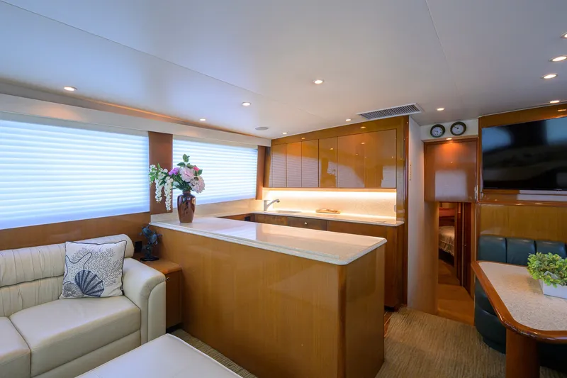 Slide: The Image of Luxurious interior of a 2001 Viking 55 Convertible yacht with modern kitchen and seating area. - 46
