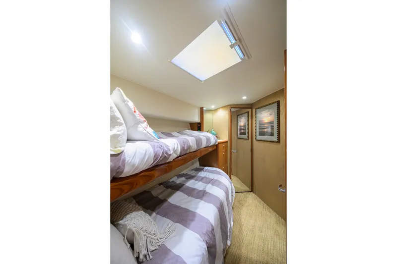 Slide: The Image of Interior of 2001 Viking 55 Convertible yacht with cozy bunk beds and skylight. - 73