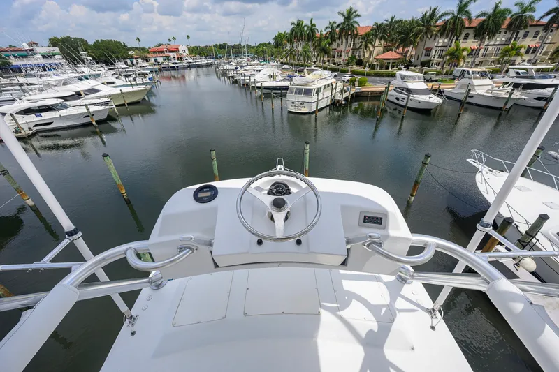 Slide: The Image of View from 2001 Viking 55 Convertible yacht helm overlooking marina with docked boats. - 37