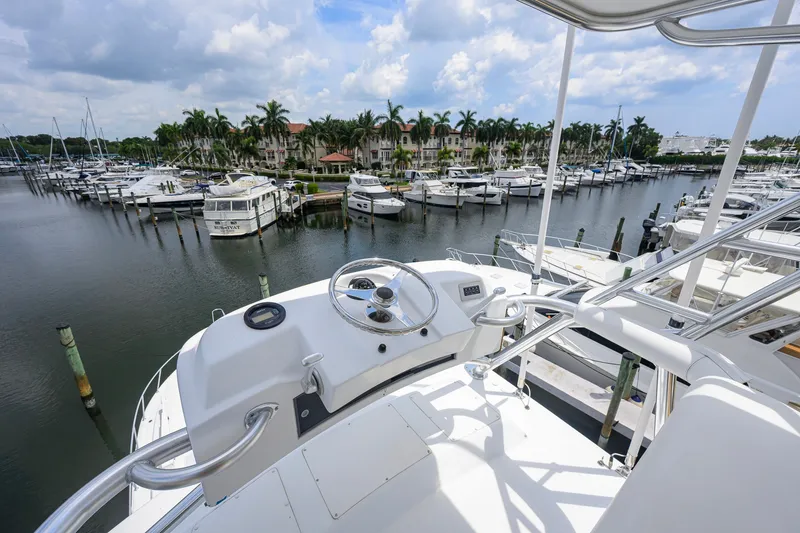 Slide: The Image of View from the helm of a 2001 Viking 55 Convertible yacht in a marina. - 38