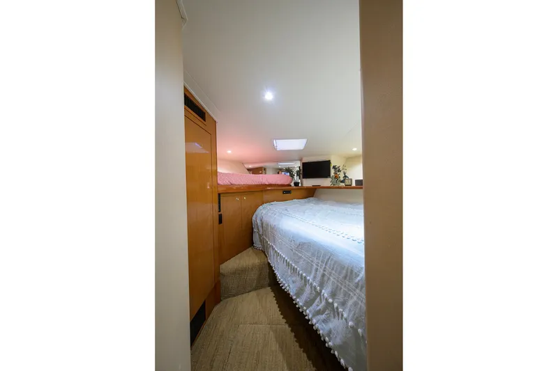 Slide: The Image of Interior cabin of 2001 Viking 55 Convertible yacht with cozy bedding and wooden accents. - 65