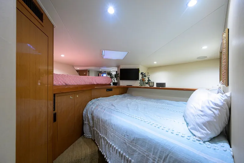 Slide: The Image of Cozy bedroom interior of 2001 Viking 55 Convertible yacht with modern amenities. - 64
