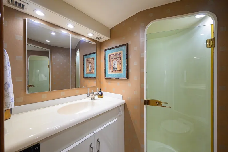 Slide: The Image of Luxurious bathroom in a 2001 Viking 55 Convertible yacht with elegant fixtures and decor. - 60