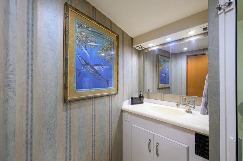 Slide: The Image of Bathroom interior of 2001 Viking 55 Convertible yacht with marine-themed artwork. - 75