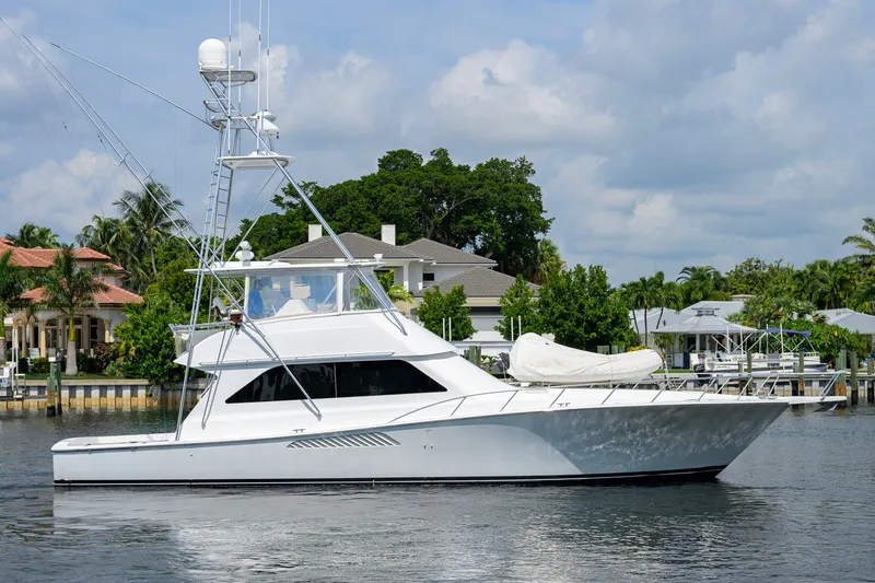 The Image of 2001 Viking 55 Convertible yacht docked near waterfront homes. - 0