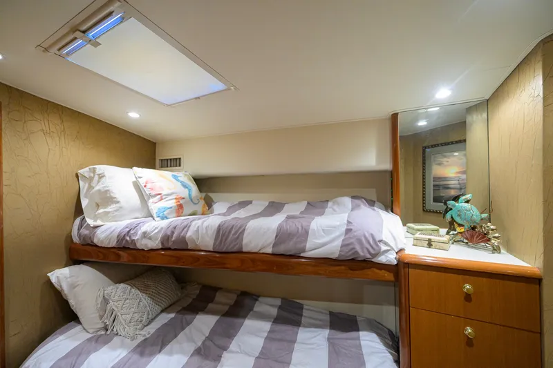 Slide: The Image of Cozy bunk beds in 2001 Viking 55 Convertible yacht cabin with decorative accents. - 69