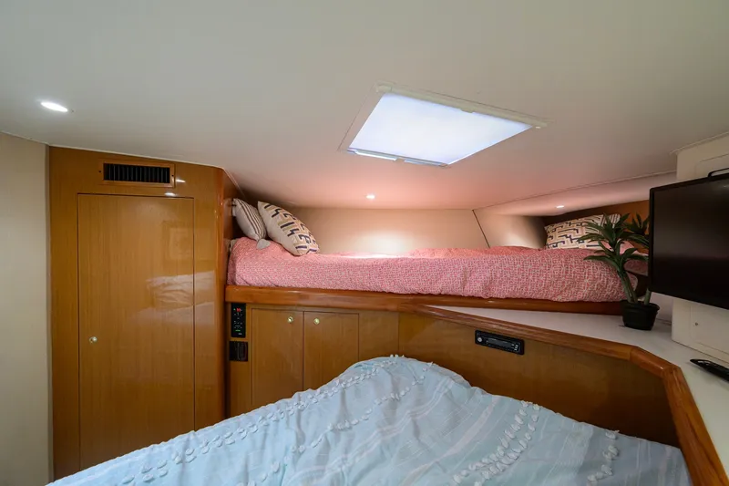Slide: The Image of Interior cabin of 2001 Viking 55 Convertible yacht with cozy bedding and modern amenities. - 67