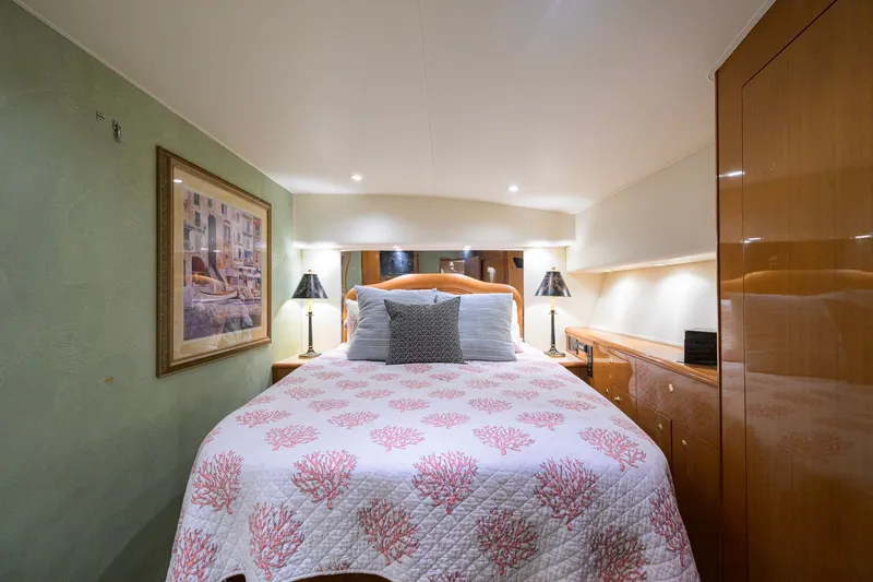 Slide: The Image of Luxurious bedroom interior of 2001 Viking 55 Convertible yacht with elegant decor and cozy bedding. - 57