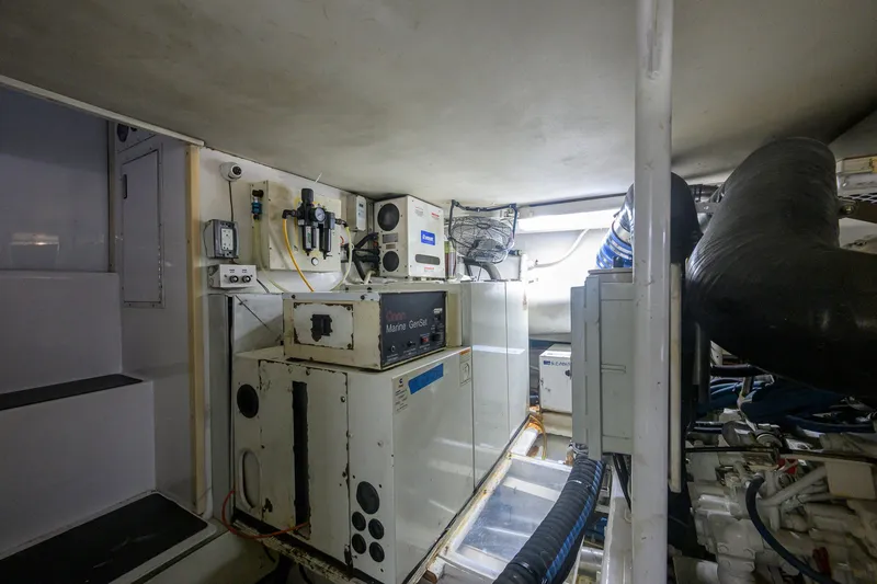 Slide: The Image of Engine room of a 2001 Viking 55 Convertible yacht, featuring marine equipment and systems. - 81