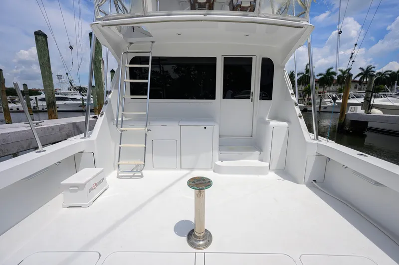Slide: The Image of 2001 Viking 55 Convertible yacht deck with ladder and marina view. - 23