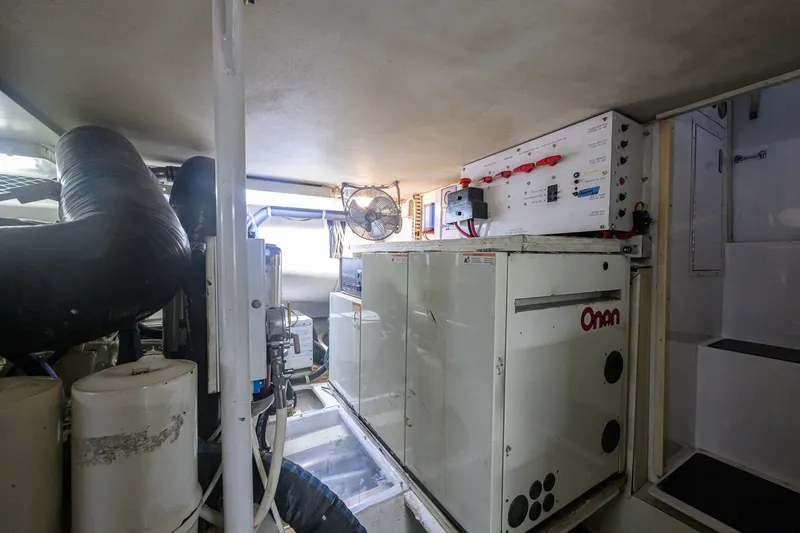 Slide: The Image of Engine room of 2001 Viking 55 Convertible yacht with Onan generator and control panel. - 79