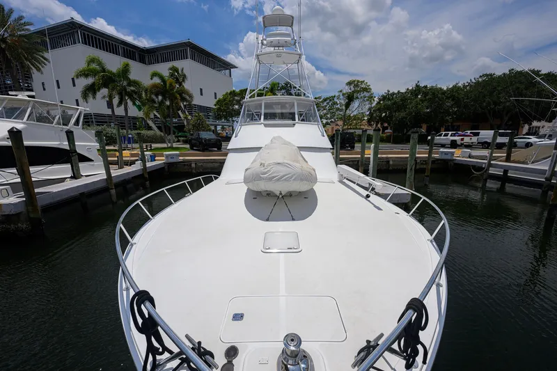 Slide: The Image of 2001 Viking 55 Convertible yacht docked at marina under a partly cloudy sky. - 13