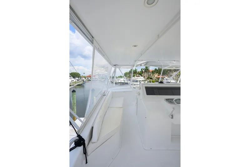 Slide: The Image of 2001 Viking 55 Convertible yacht interior with helm station and marina view. - 32