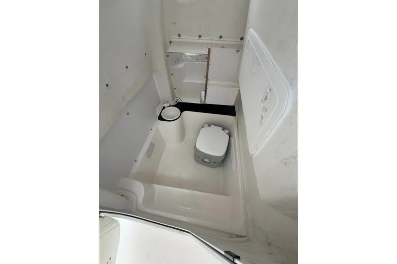Slide: The Image of Interior of 2018 Sea Fox 266 Commander boat, featuring compact marine toilet setup. - 7