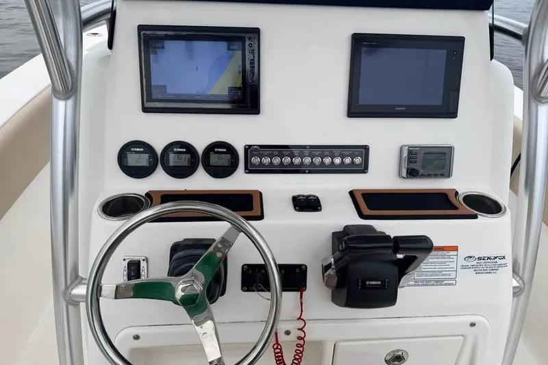 Slide: The Image of 2018 Sea Fox 266 Commander dashboard with navigation screens and controls. - 12