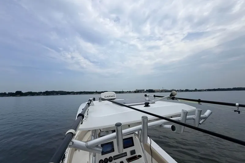 Slide: The Image of 2018 Sea Fox 266 Commander boat on calm water under cloudy sky. - 8