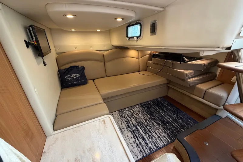Slide: The Image of Interior of 2015 Rinker 340 Express Cruiser with beige seating and modern amenities. - 27