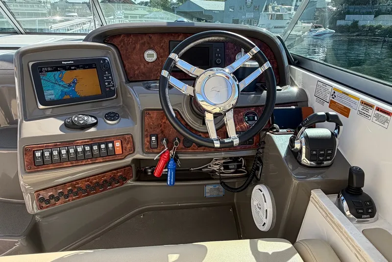 Slide: The Image of Cockpit of 2015 Rinker 340 Express Cruiser with navigation system and controls. - 20