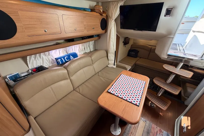 Slide: The Image of Interior of 2015 Rinker 340 Express Cruiser with beige seating and wooden accents. - 28