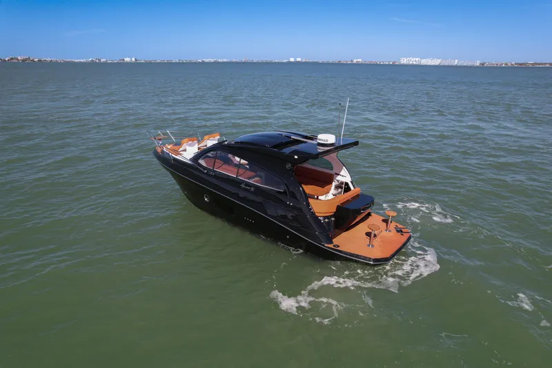 Slide: The Image of Luxurious 2026 Hanover 355 yacht cruising on open water under clear blue skies. - 2