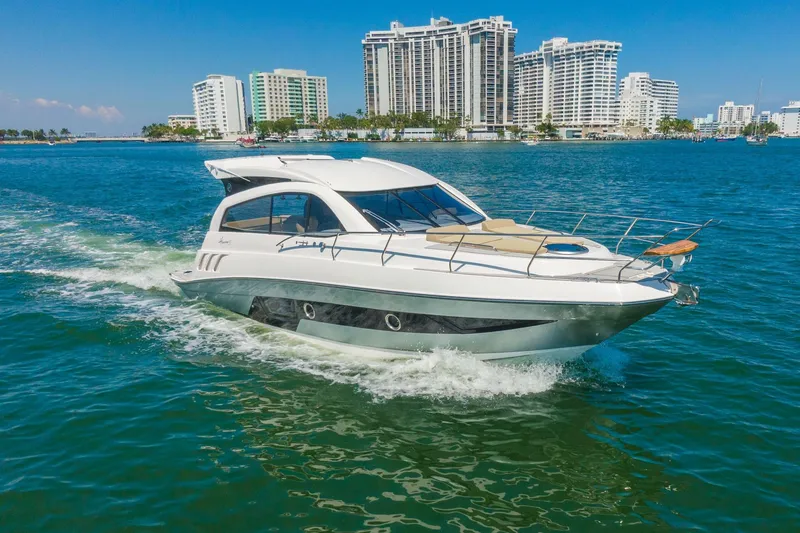 The Image of Luxurious 2026 Hanover 375 yacht cruising in vibrant coastal waters with city skyline backdrop. - 0