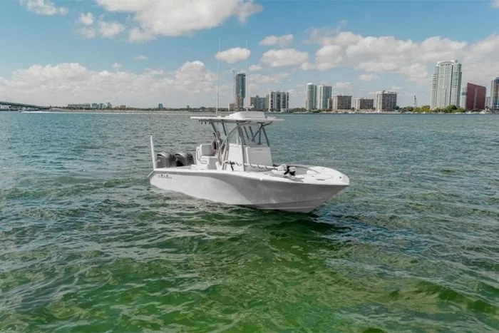 Slide: The Image of SeaHunter 25 Floridian 2027 on calm waters with a city skyline in the background. - 4