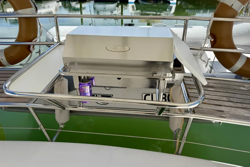 Slide: The Image of Marine-grade stainless steel gas barbecue grill. This highly praised feature is integrated directly into the aft cockpit rail framework, between the two aft bench seats. It connects directly to the yacht's central propane system - 11