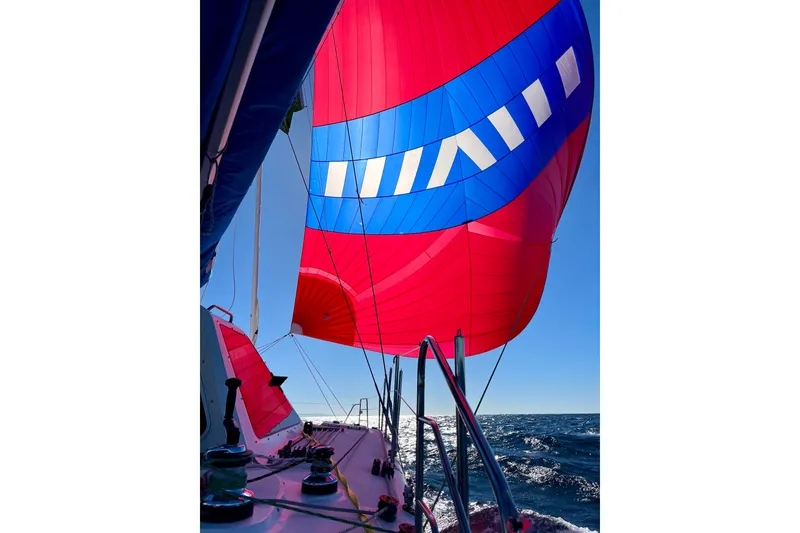 Slide: The Image of Sailing on a 2009 Seawind 1160 with vibrant red and blue spinnaker. - 4
