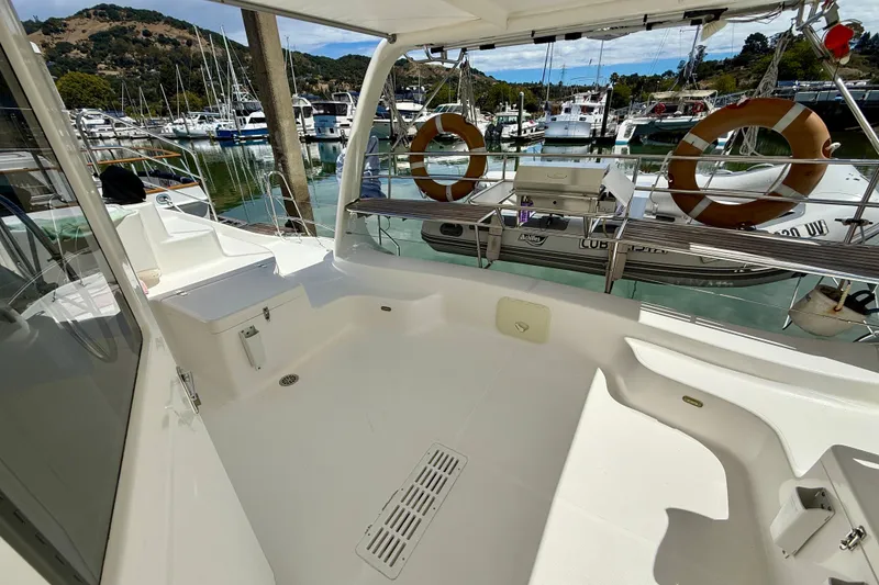 Slide: The Image of CUBO LISTA cockpit looking aft featuring life rings dinghy on davits and outdoor seating. - 10